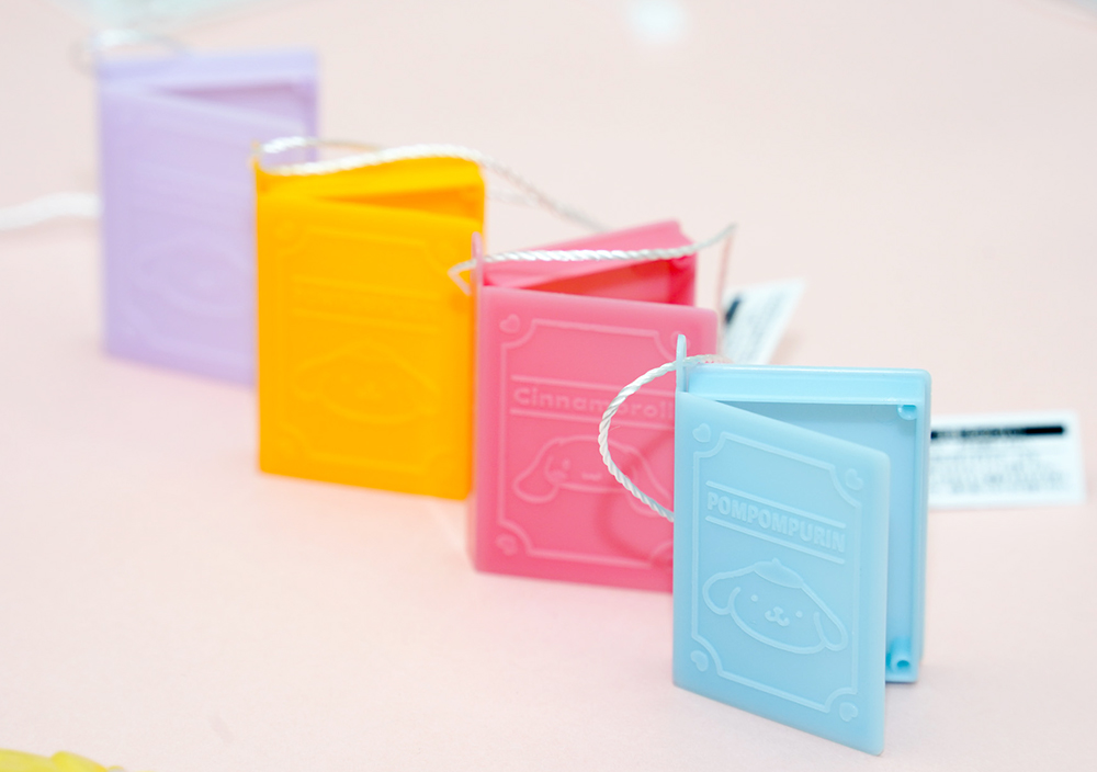 A row of miniature containers in soft colors.